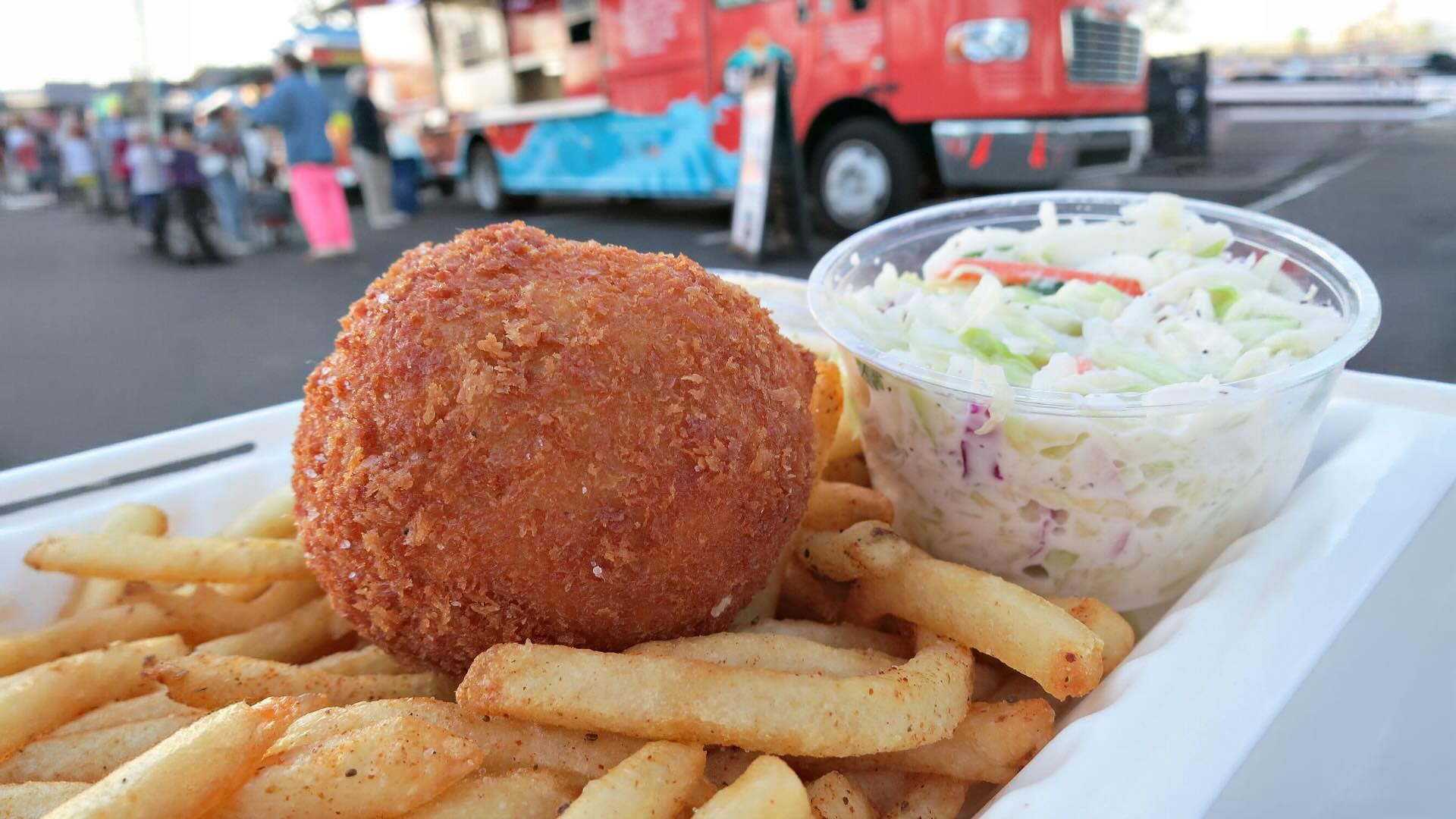 Crispy Crab Cake with Old Bay Fries and Coleslaw and Sam's ChowderMobile with line of patrons in background