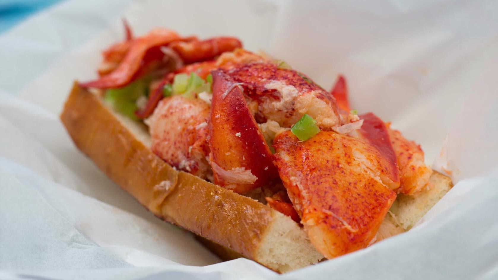 lobster roll sandwich with Maine lobster lightly tossed in warm butter on toasted bun from Sam's ChowderMobile