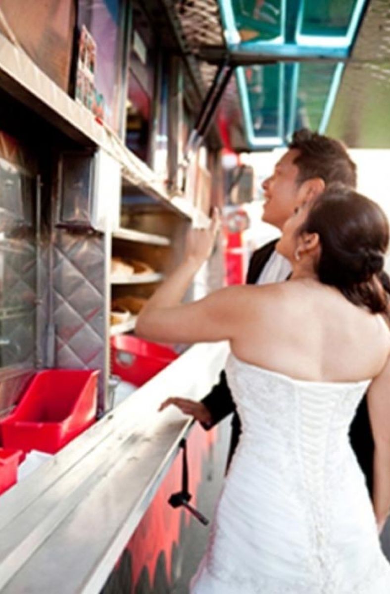 bride and groom happily ordering dinner from Sam's ChowderMobile at their outdoor Bay Area wedding reception