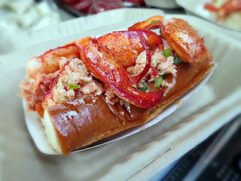 closeup of lobster roll sandwich from Sam's ChowderMobile features delicious Maine lobster lightly tossed in warmed butter on a toasted bun