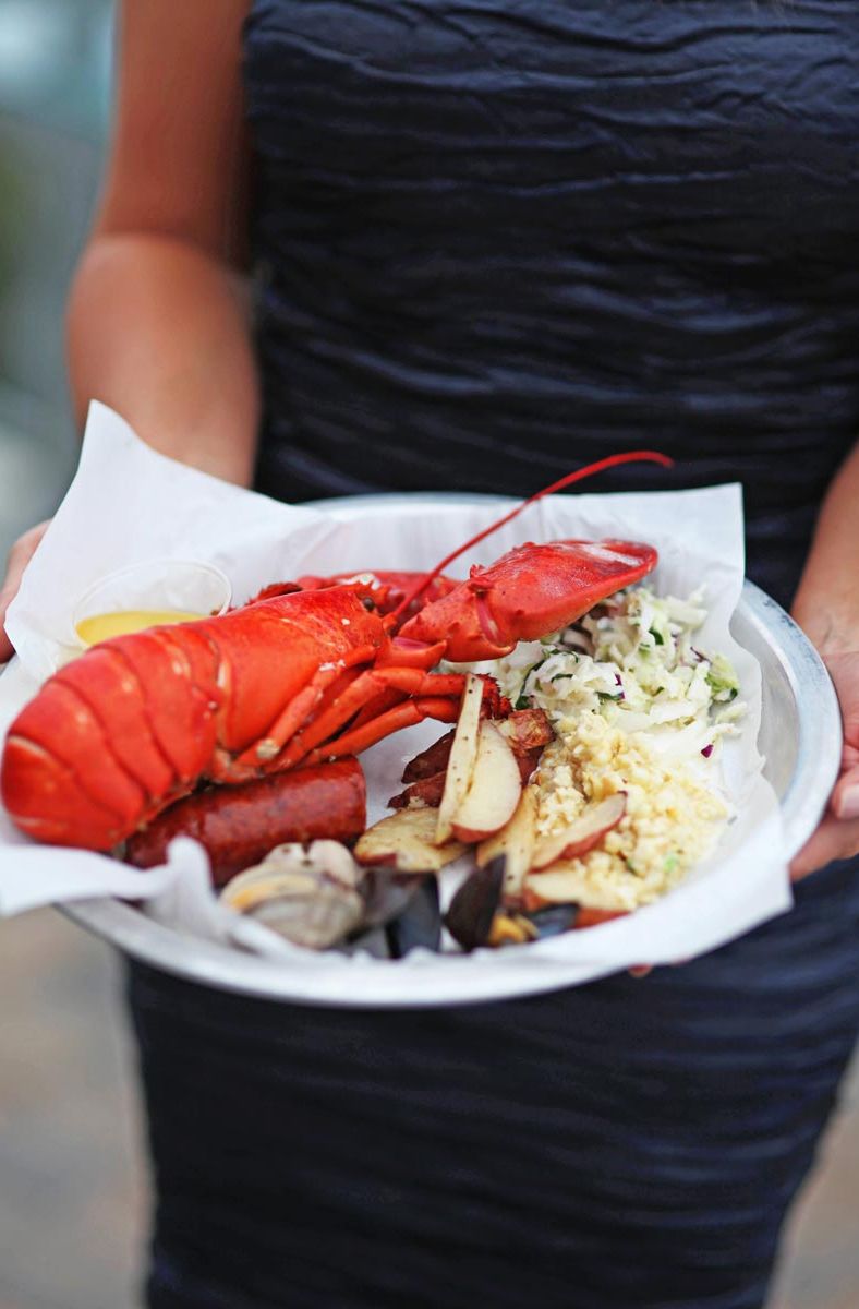 Sam's Lobster Clambake plate closeup in wedding guest's hands